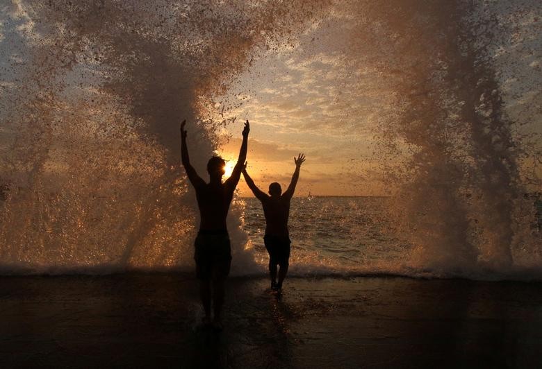 People pose for a photo during a storm in Sevastopol, Crimea. REUTERS/Alexey Pavlishak  